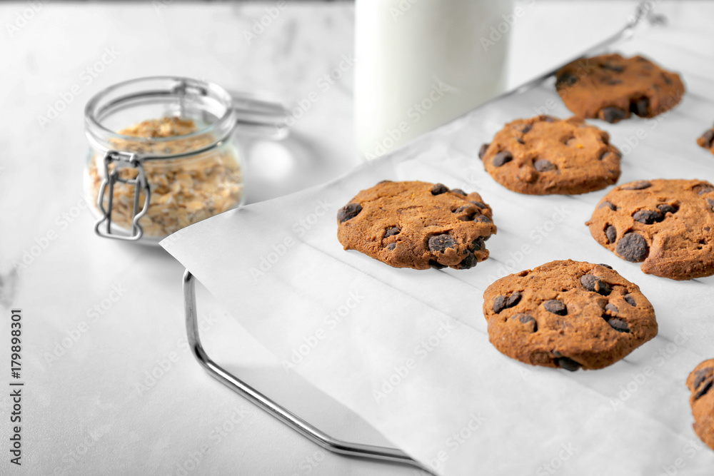 Delicious oatmeal cookies with chocolate chips on table