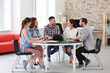 © Africa Studio - Team of young professionals conducting business meeting in office