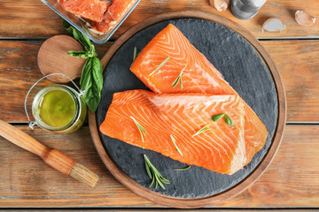 Wall Mural - Fresh raw salmon fillet and marinade on wooden table