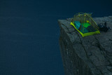 Fototapeta Natura - Tent on mountain cliff edge