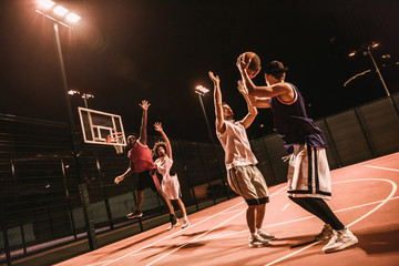 Guys playing basketball