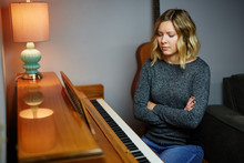 Young Blond Woman Next To Piano Upset