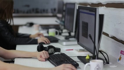Cinemagraph with hands of software developers working in a software developing company office
