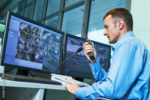 Security worker during monitoring. Video surveillance system. Poster Mural XXL