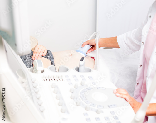 Fotografie, Obraz Doctor operating ultrasound machine performing obstetric ultrasonography focus o