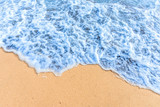 Fototapeta Morze - Soft wave with blue ocean on sandy beach.