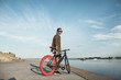 © Westend61 - Young man with fixie bike at the waterfront