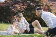 © Westend61 - Gay couple playing with their child in the garden