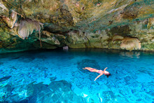 Cenote Dos Ojos In Quintana Roo, Mexico. People Swimming And Snorkeling In Clear Blue Water. This Cenote Is Located Close To Tulum In Yucatan Peninsula, Mexico.