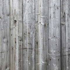 part of fence with grey weathered vertical planks