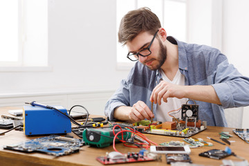 Poster - Repairman disassemble motherboard with screwdriver