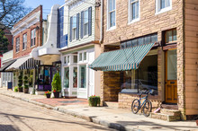 Traditional American Stores Along A Cobblestone Street