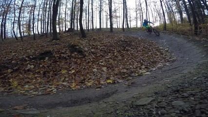 Wall Mural - Mountain cycling in autumn mountains forest landscape. Man cycling MTB flow trail track. Outdoor sport activity.
