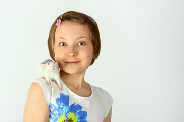 Shot of a happy little girl holding a Rat. Portrait of a little girl playing with her pet rat.   Portrait of a pretty young girl with her pet  rat.
