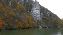 Autumn At The Danube Gorges, The Border Between Romania And Serbia. View With The Decebal King's Head Sculpted In Rock And Inscription "DECEBAL REX - DRAGAN FECIT" (Decebal King - Made By Dragan).