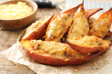 Plate with yummy stuffed sweet potato on kitchen table