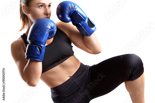 Cuadros en Lienzo Female kickboxer on light background