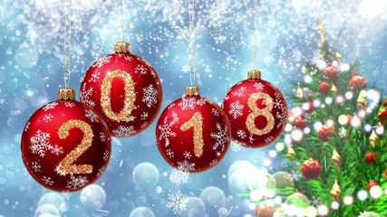 Wall Mural - red balls with numbers 2018 hanging on the background of a blue bokeh and a rotating christmas tree 