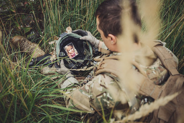 soldier holding a helmet in his hand