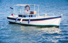 White Wooden Fishing Boat Anchored In Port