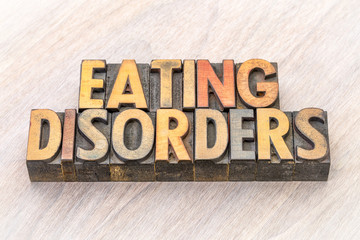 Wall Mural - eating disorders word abstract in wood type