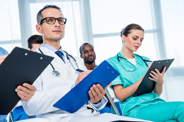 Wall Mural - multiethnic group of doctors with clipboards