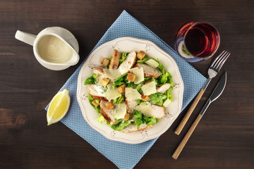 Wall Mural - Chicken Caesar salad on rustic background with copyspace