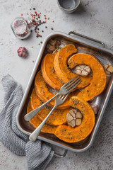 Wall Mural - roasted pumpkin slices with spicy herbs and garlic