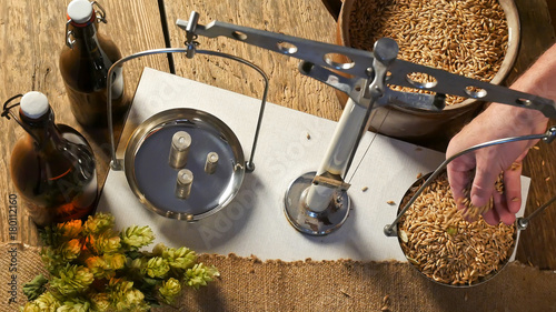 Cuadros en Lienzo Man Weighs Malt for Home Brewing of Beer.