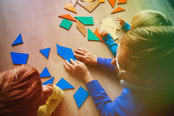 Wall Mural - teacher and kids playing with geometric shapes puzzle