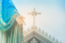 Hand Of The Blessed Virgin Mary Statue Standing In Front Of The Roman Catholic Diocese With Crucifix Or Cross And Blue Sky In The Background At Chanthaburi Province, Thailand.