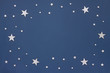 © X-tina - Christmas silver stars on dark blue background. Stars sky, flat lay, top view