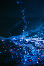 Dark Blue Glitter Background. Crystal Glistening Waterfall Concept