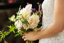Bride bridesmaid holding wedding flower bouquet