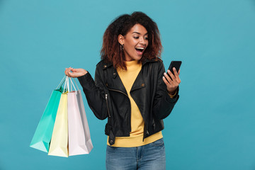 Sticker - Excited amazing young african woman holding shopping bags