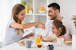 © Syda Productions - happy family having breakfast at home