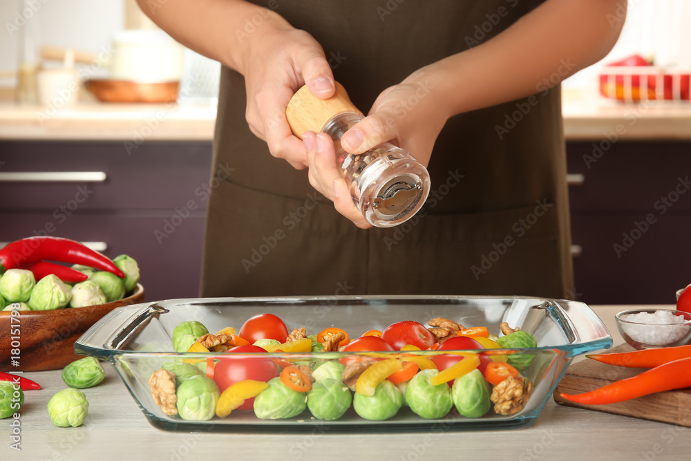 Woman cooking brussels sprouts on table