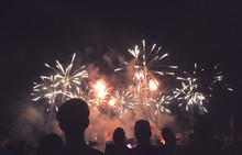 Crowd Of Silhouetted People Watching A Fireworks Display For New Years Or Fourth Of July Celebration, Horizontal