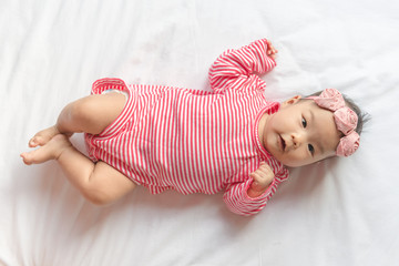 Close up cute baby with Headband lying on the bed