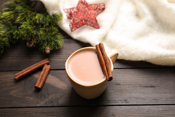 Poster - Mug with delicious cocoa drink on wooden background