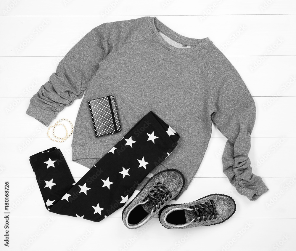 Set of child's clothes on wooden background