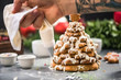 © marcin jucha - Decorating gingerbread Christmas sweet tree with frosting