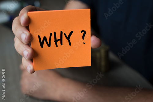 Fotografía Hand holding an orange Paper with the word why - Why?, Business Concept