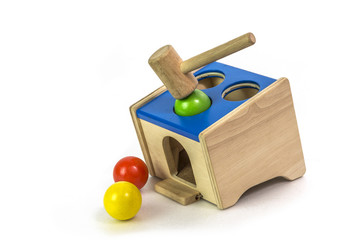 Playing Wood hammer and wood ball toy.