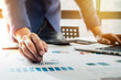 © Jirapong - Businessman pen pointing graph chart in this month for  Plans to improve quality next month.