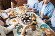 © pressmaster - Young female bringing birthday cake with cream dollops on plate for her guests