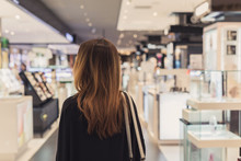 Young Asian Woman Walking In Cosmetics Department At The Mall