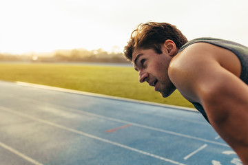 Wall Mural - sprinter standing on running track