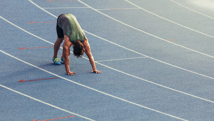 Wall Mural - sprinter warming up on the track