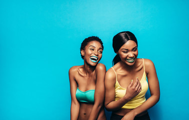 Wall Mural - Cheerful women standing together and laughing